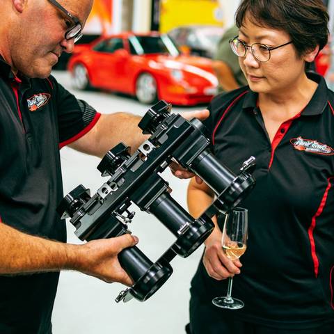 Guests handling a Rennen ITB throttle body bank at an event