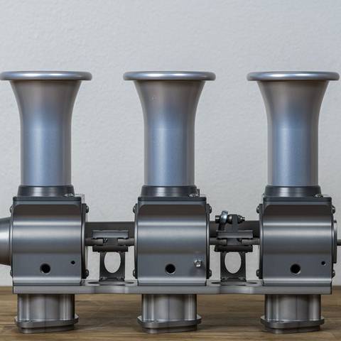 Throttle body bank with tall velocity stacks, three-quarter view
