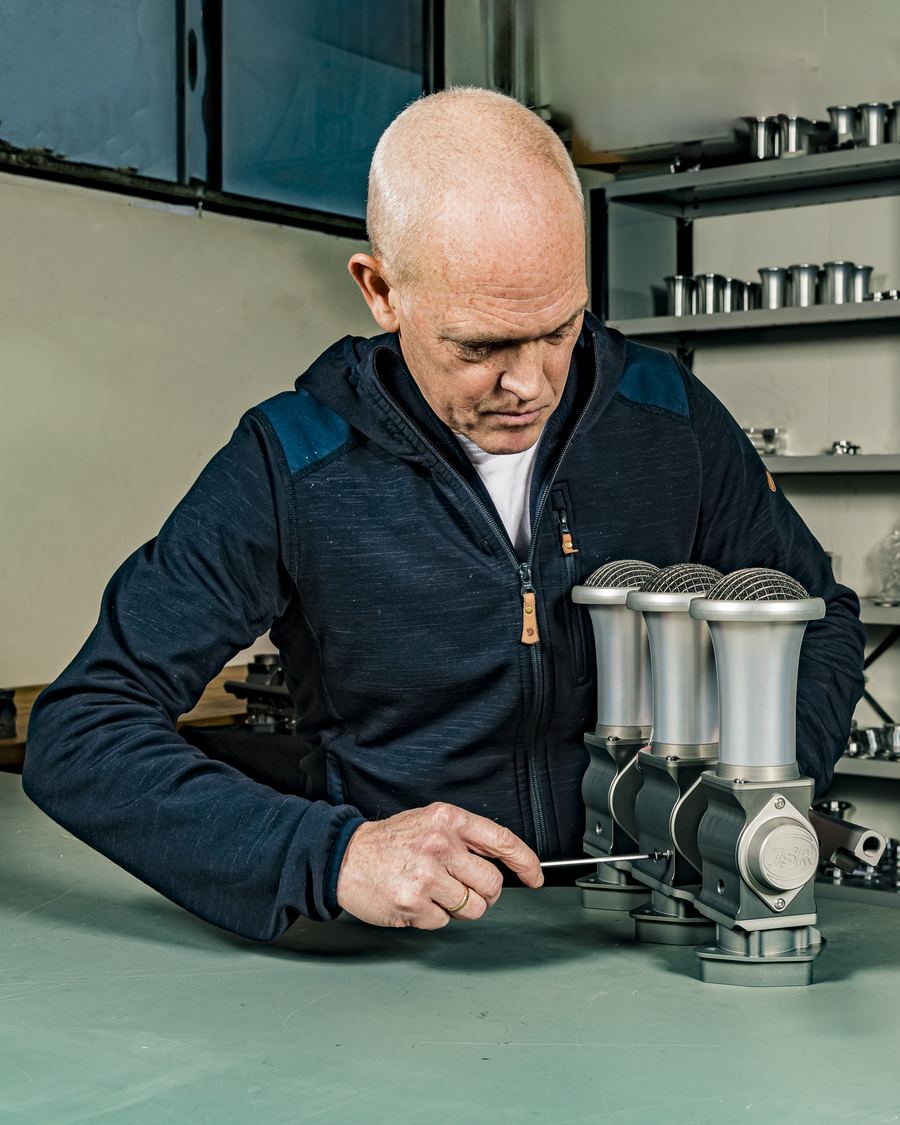 JSR Engineering craftsman setting the throttle linkage on a hand-built Rennen ITB system, velocity stacks fitted